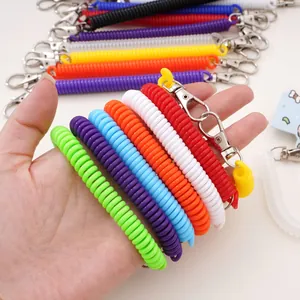 Close-up of colorful spiral spring keychains with metal carabiner clips for keys