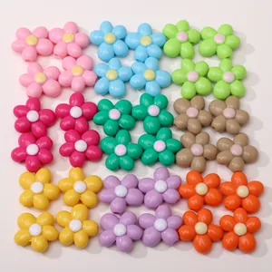 Flat lay of colorful five-petal acrylic flower beads for DIY jewelry and crafts