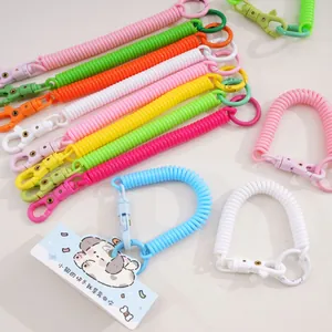 Macro view of colorful spiral spring keychain ropes with matching plastic buckles