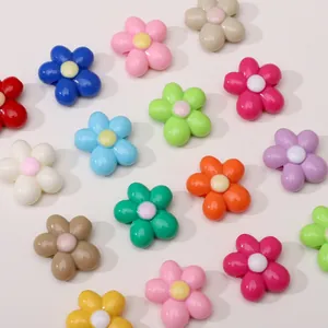 Flat lay of colorful acrylic flower charms for DIY jewelry and phone accessories