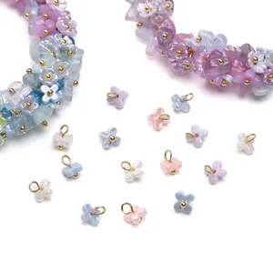 Macro detail of pastel lily of the valley resin flower charms for DIY jewelry making
