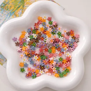 Handmade DIY resin 5-petal flower accessories in pastel colors on a petal-shaped ceramic plate