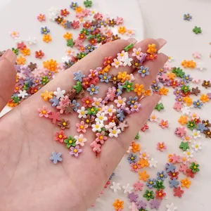 Colorful 7mm resin flower charms for DIY crafts and phone case decoration on white background