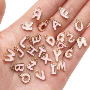 Detailansicht der rosa Emaille-Buchstabenanhänger aus Goldlegierung für DIY-Schmuck