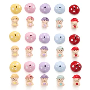 Macro shot of colorful enamel mushroom beads and doll charms for DIY jewelry making