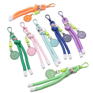 Detail of colorful woven nylon smiley face keychains with matching metal hooks and tags