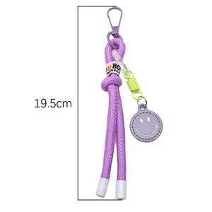 Detail of purple woven nylon keychain with smiley face charm and 19.5cm size mark