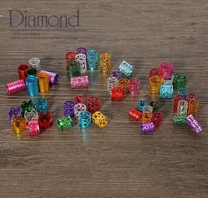 Close-up of colorful crown-shaped aluminum beads and textured rings for DIY hair jewelry