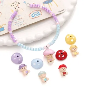 Detail of colorful resin mushroom charms and pastel beads for DIY jewelry making