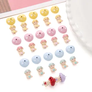 Macro detail of colorful mushroom DIY beads and doll pendants for handmade jewelry