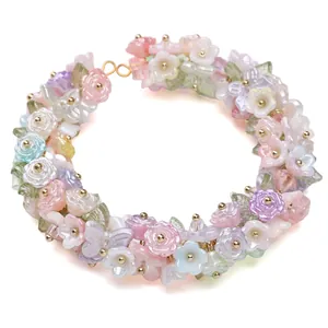 Detail of macaron butterfly pearls and resin flower beads with golden lobster clasp
