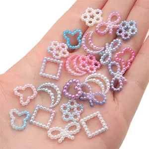 Macro shot of colorful gradient pearl charms in star, moon, and bear shapes for DIY crafts