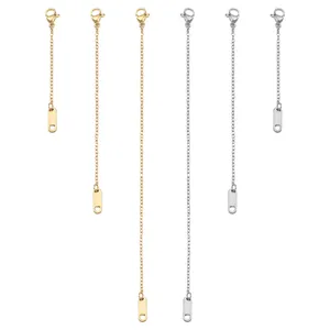 Detail of stainless steel extender chains with lobster clasps and tags in gold and silver