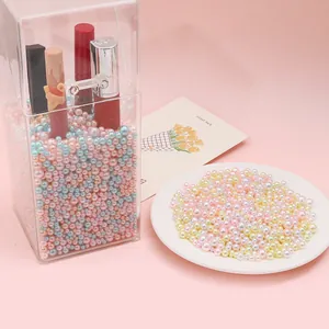 Pastel faux pearls in makeup organizer showing lipsticks with a pink background