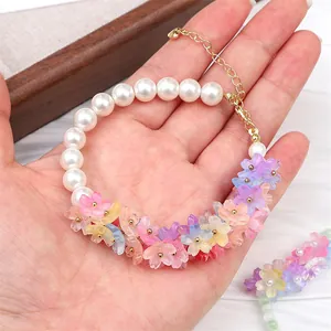 Detailed view of handmade gradient flower beads and white pearls on a floral DIY bracelet