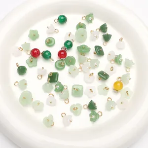 Macro view of assorted green faux jade pendants and beads for handmade DIY jewelry