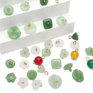 Assorted jade-style glass charms in various colors and shapes with gold metal loops