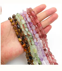 Close-up of irregular natural stones including tiger eye and amethyst for DIY jewelry making