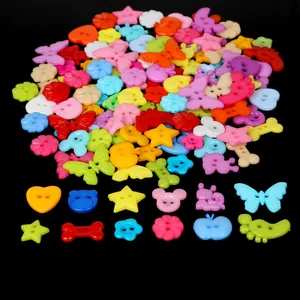Assorted colorful plastic DIY buttons in star heart and animal shapes on black background