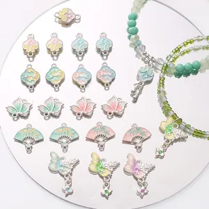 Detail of traditional Chinese alloy charms with lotus and butterfly enamel designs