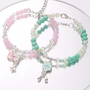Detail of beaded bracelets with butterfly and cloud enamel charms and silver lobster clasp