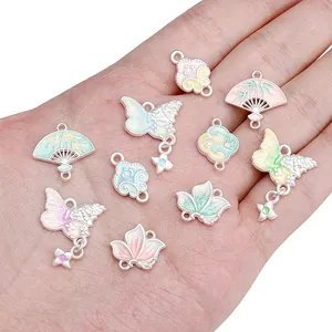 Handheld vintage alloy drip oil pendants in butterfly and fan shapes for DIY jewelry