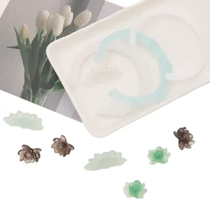 Close-up of resin lotus pendants and bamboo-shaped bracelet accessories for DIY jewelry