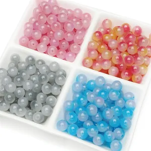 Macro shot of colorful jelly round glass beads in a white organizer tray for DIY jewelry