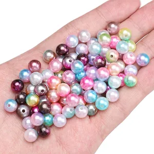 Colorful gradient ABS faux pearl beads for DIY jewelry making held in palm