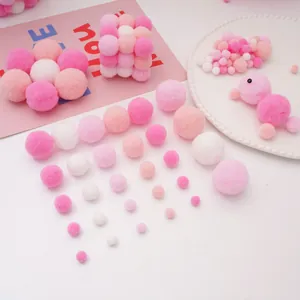 Macro shot of colorful craft pom-poms in pink and white tones for DIY creative handwork