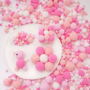 Creative craft kit featuring pink plush pompoms in various shapes and floral arrangements