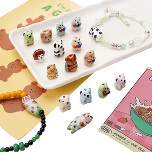 Hand-painted ceramic animal beads for DIY bracelets and phone charms with panda and bear shapes