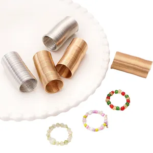 Macro detail of metallic gold and silver spiral wires with handmade colorful bead rings