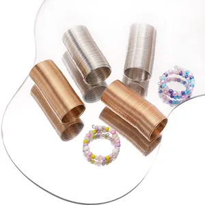 DIY jewelry making kit featuring gold and silver memory wire coils with colorful beads