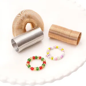 DIY jewelry kit with gold and silver steel wire coils and colorful handmade beaded rings
