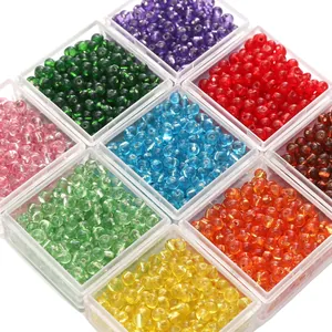 Assorted 4mm glass seed beads in multiple colors organized in a plastic grid box for DIY