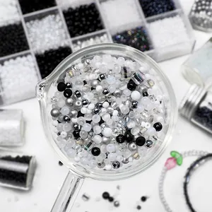 Macro shot of 2-4mm black and white glass seed beads for DIY jewelry making sets