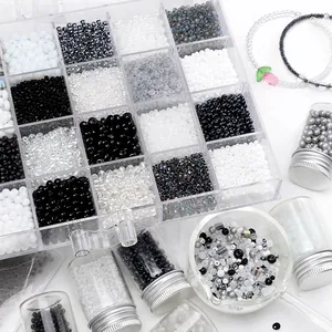 DIY bead set with black and white glass seed beads in a plastic storage box and glass bottles