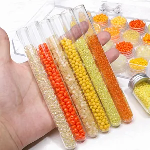 DIY glass seed bead jewelry kit with orange beads in glass tubes and storage boxes