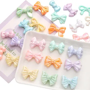 Macro detail of iridescent acrylic bow beads in macaron colors for DIY jewelry making