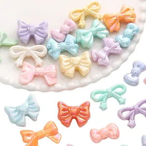 Detailed view of colorful acrylic bow-shaped DIY beads with heart and star patterns