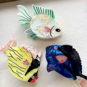 Three acetate fish hair claws in green pearl, yellow pink stripes and deep blue colors