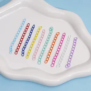 Close-up of ten colorful alloy chain links in a white tray for DIY jewelry making