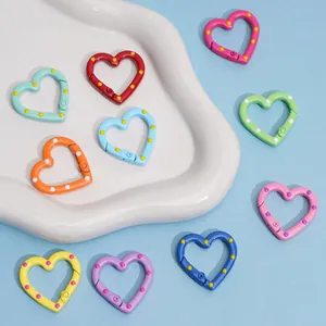Colorful heart-shaped polka dot spring clasps for DIY jewelry and keychains on tray