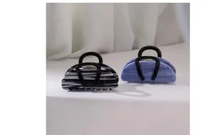 Detailed view of acetic acid hair claw clip in handbag shape with Creation France print