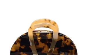 Detailed view of acetate hair claw clip with tortoise shell pattern and glossy finish
