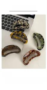 Detailed view of tortoiseshell pattern acetate hair claws in five various colors
