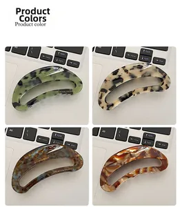 Selection of acetate claw hair clips in floral, leopard, and amber patterns displayed on laptop
