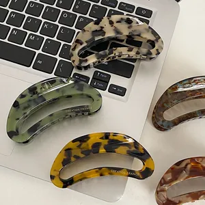 Large acetate hair claw clip with vintage tortoiseshell pattern and crescent shape