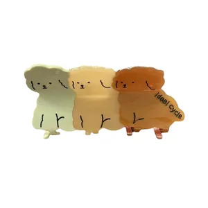 Tre fermagli per capelli in acetato a forma di cane in verde, beige e marrone opaco